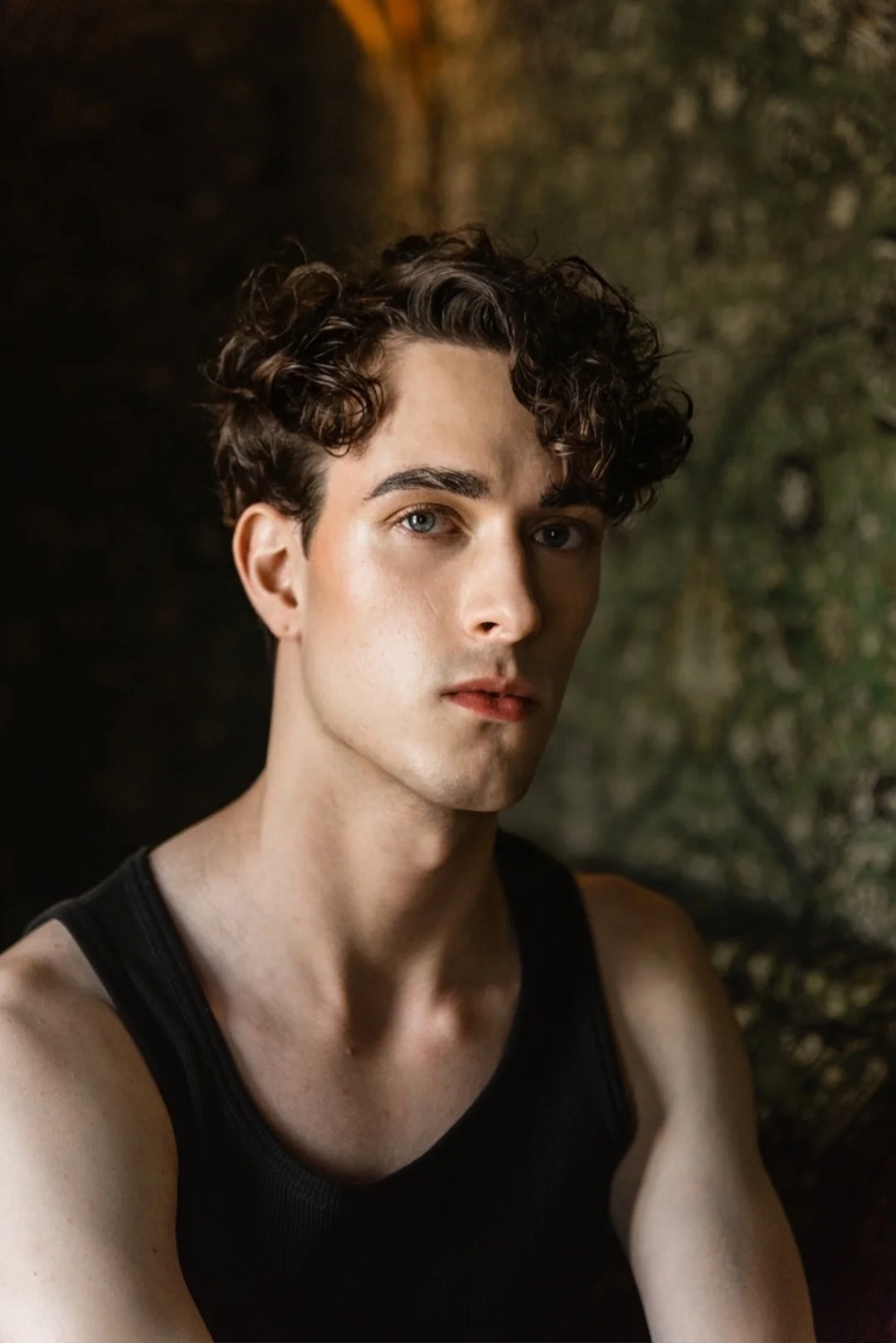 Jules Sauvage, gay male escort Paris — boyfriend experience portrait, black tank, direct gaze