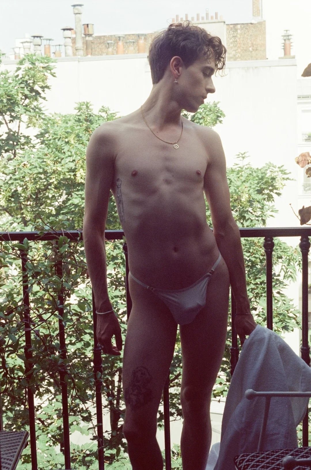 Silhouette on a Paris balcony — independent gay male escort Paris, slow afternoon