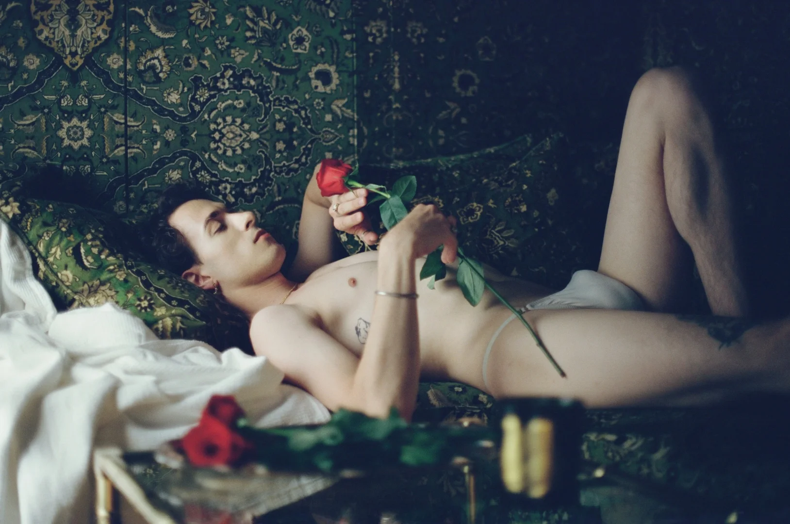 Boyfriend experience intimacy — rose and unmade bed, gay male escort Paris
