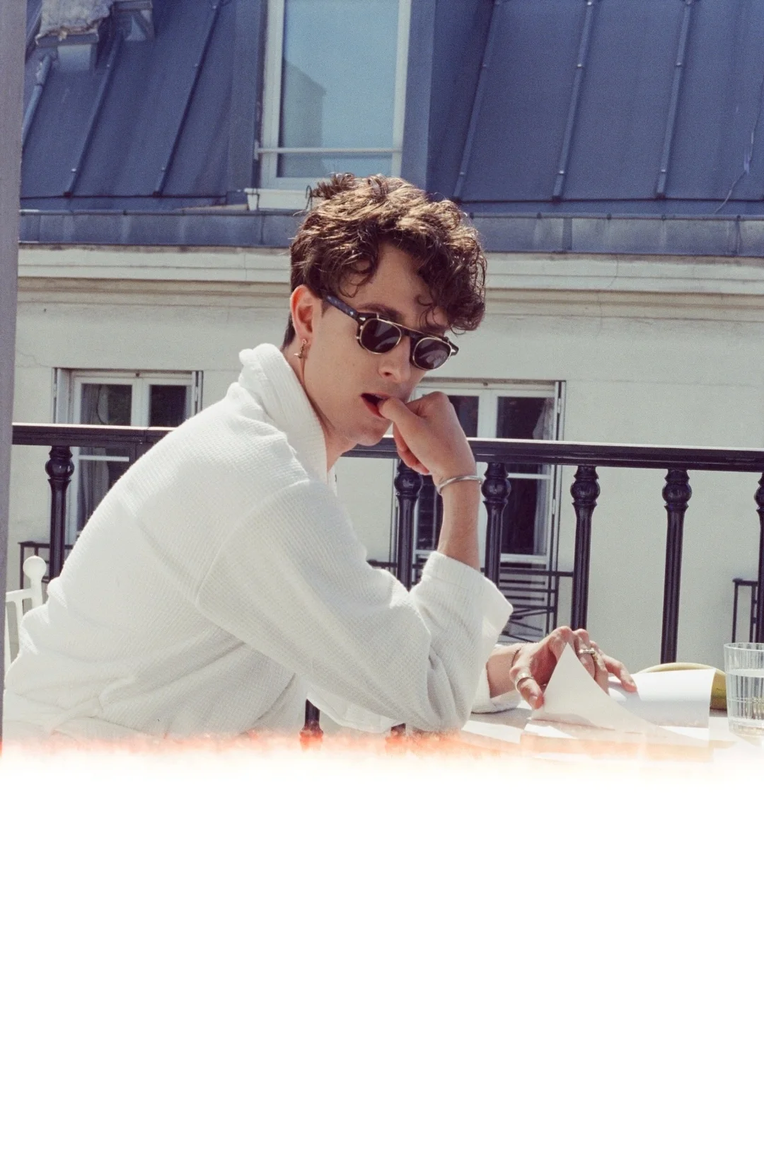 Boyfriend experience Paris — morning coffee in a bathrobe on a Paris balcony, dark sunglasses