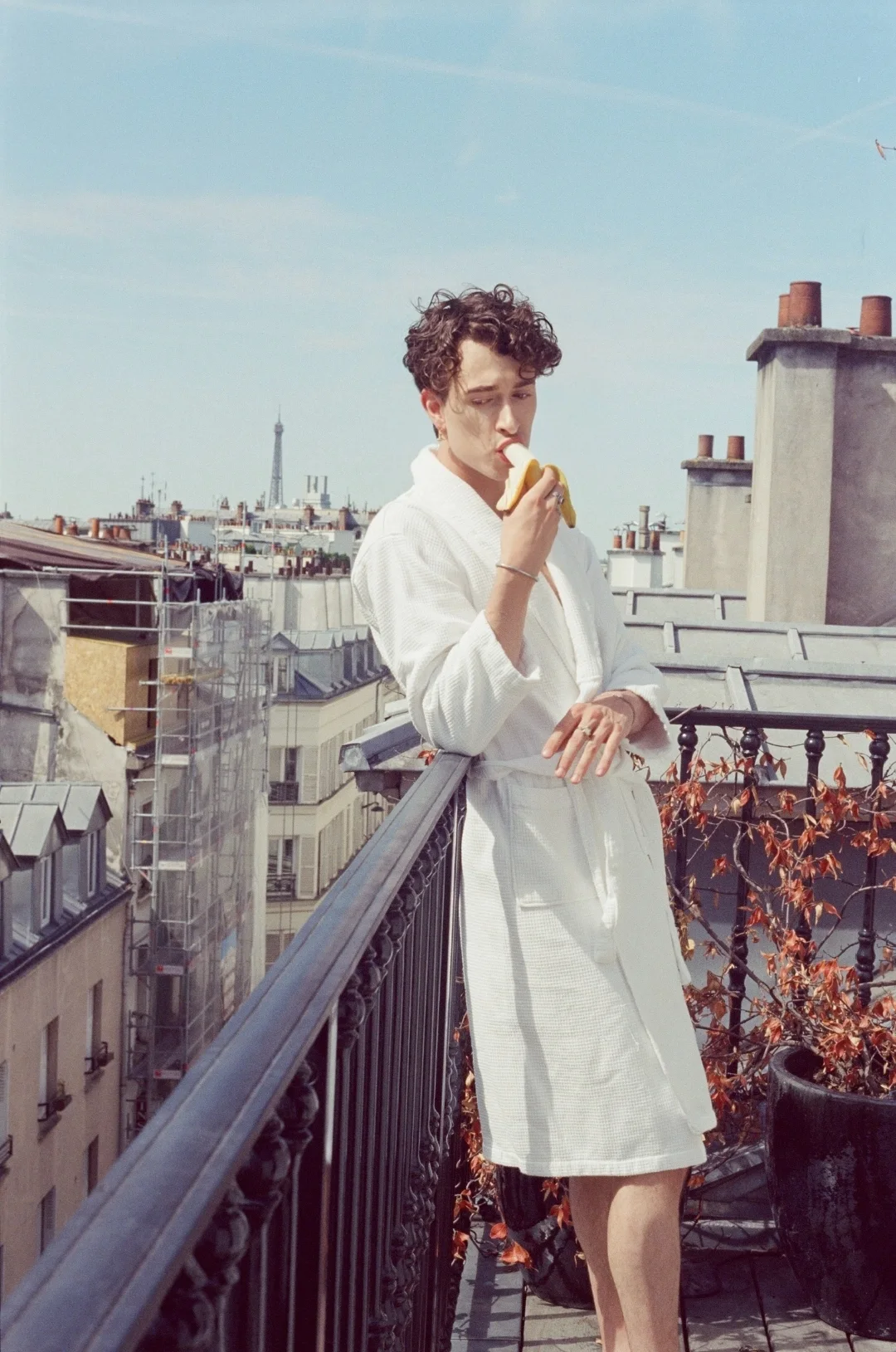 View over Paris and the Eiffel Tower — gay boyfriend experience Paris, white bathrobe on the balcony